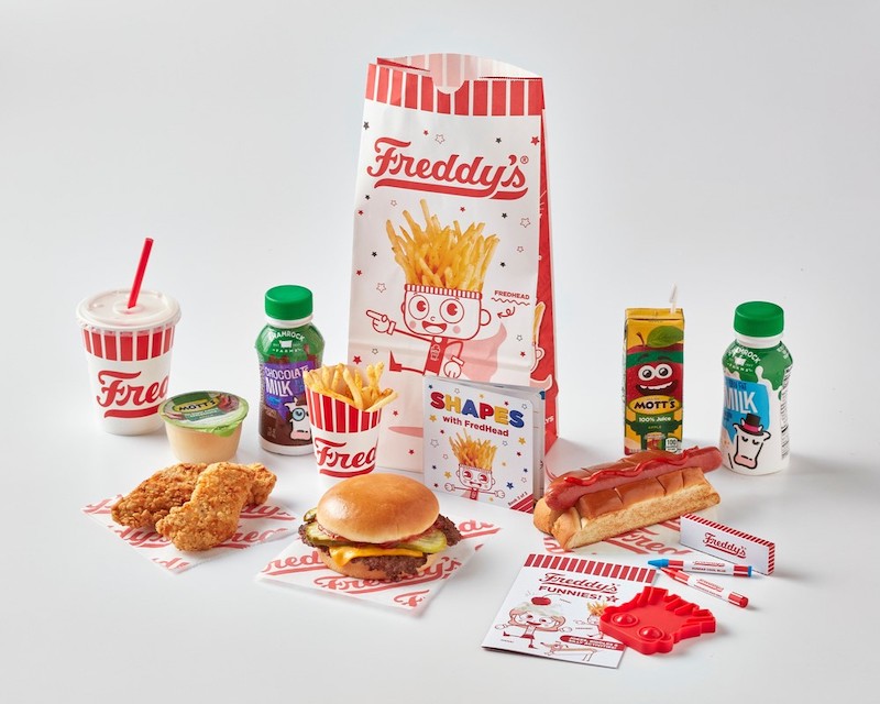 Freddy’s kids meal with steakburger, hot dog, fries, chicken tenders, drinks, and activity items